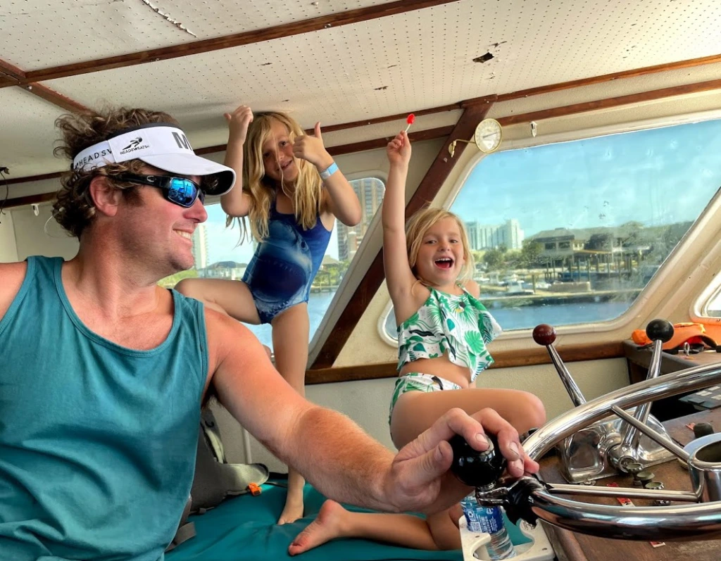 Captain and daughters on offshore charter boat fishing trip out of Fort Morgan, Alabama.