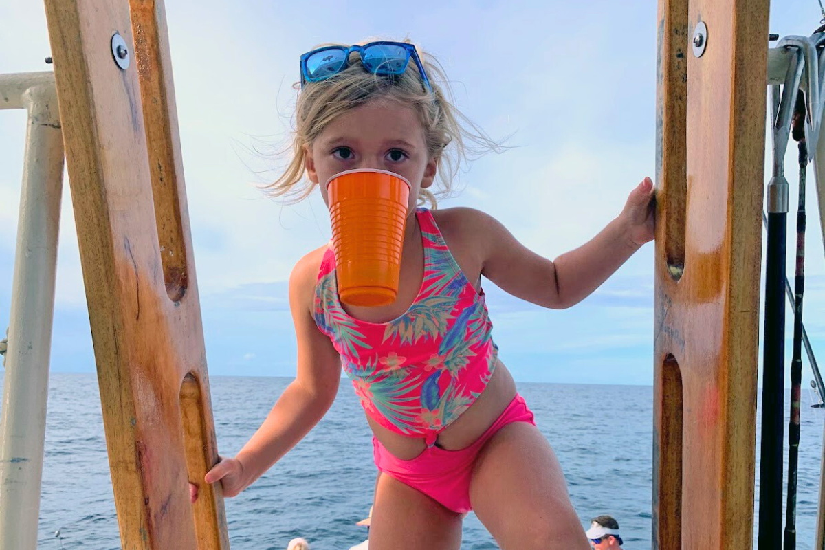 girl having fun on kids charter fishing boat trip out of fort morgan, gulf shores, alabama