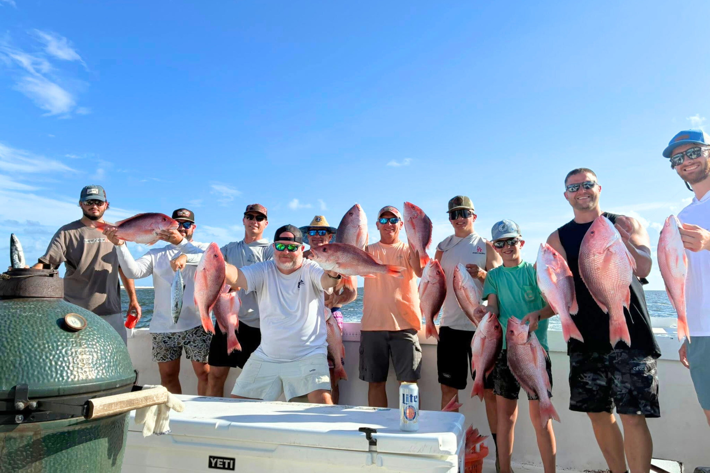 group of fishermen showing off their red snapper after full day fishing trip out of Fort Morgan marina