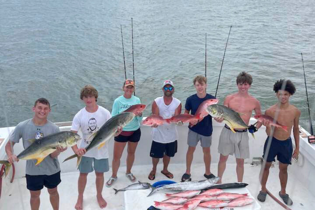 group of guys enjoying a fun afternoon on the gulf of america aboard recreational fishing charter boat