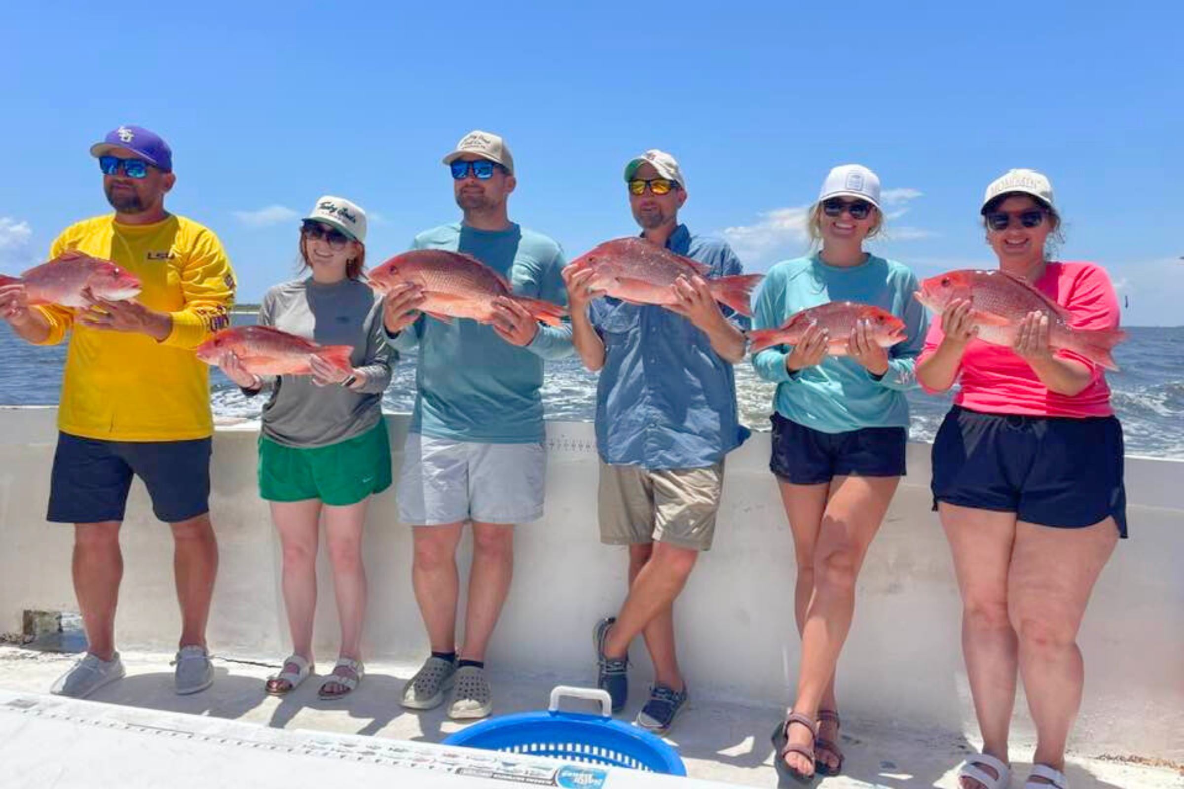 family group enjoying a sunny day at the beach on offshore recreational fishing trip out of Gulf Shores, Alabama