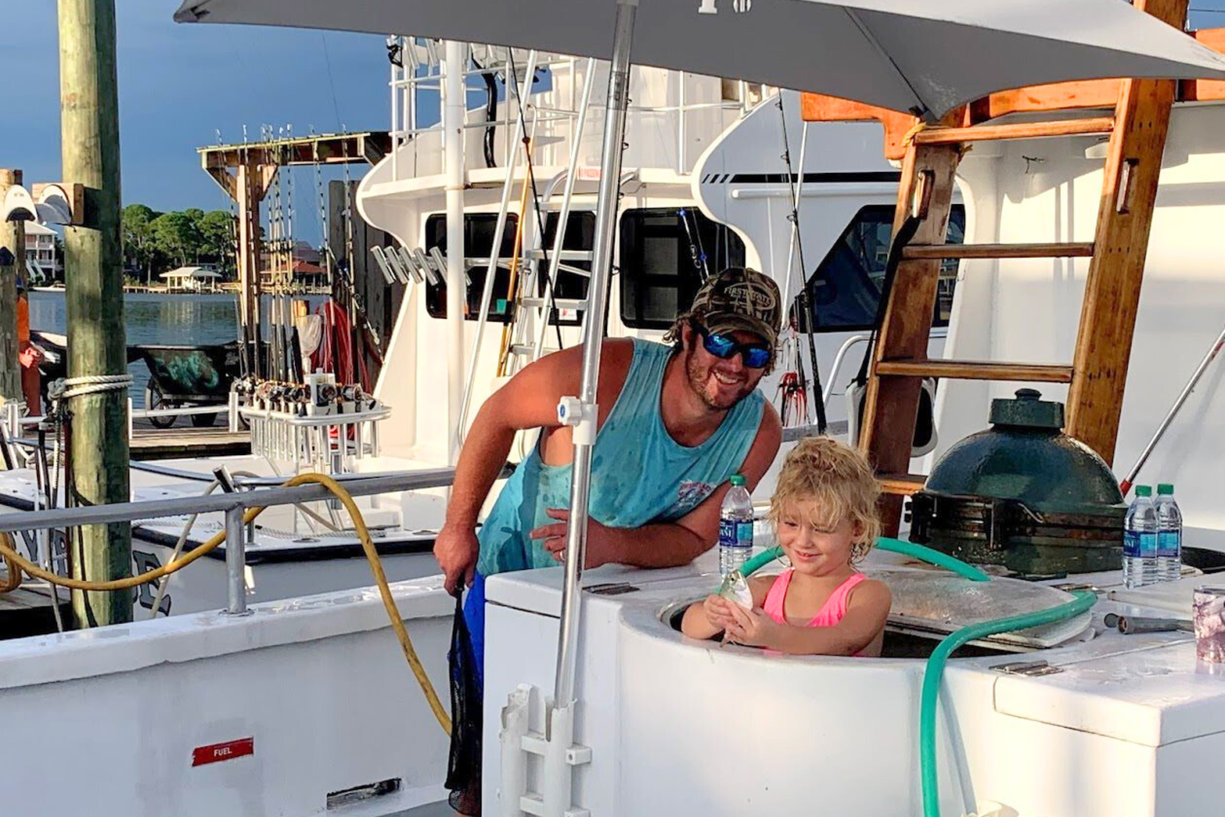 funny picture of girl swimming in the live well aboard the No Doubt at Zeke's Marina