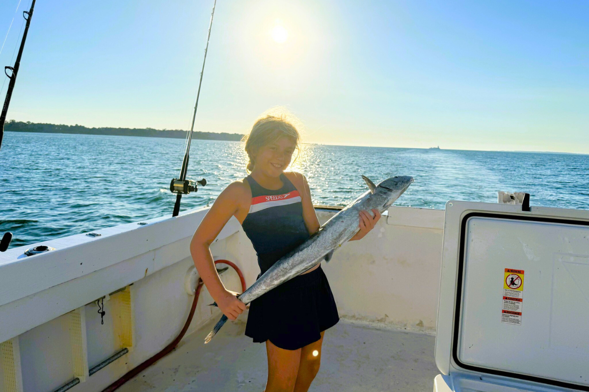 girl showing off large fish she caught in the Gulf of America out of<br />
Fort Morgan, Alabama