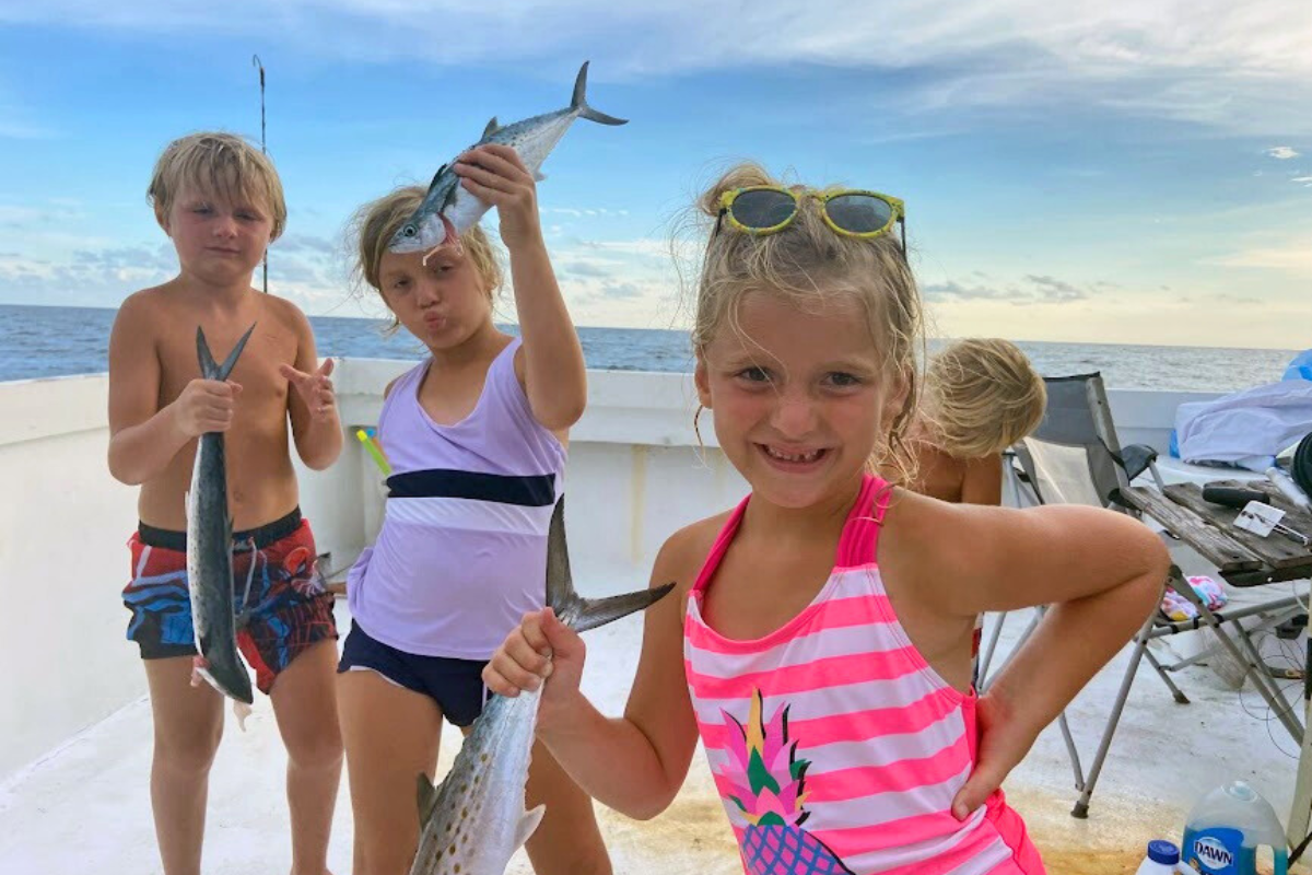 group of kids enjoying a fun day out on the water on vacation in gulf shores, alabama