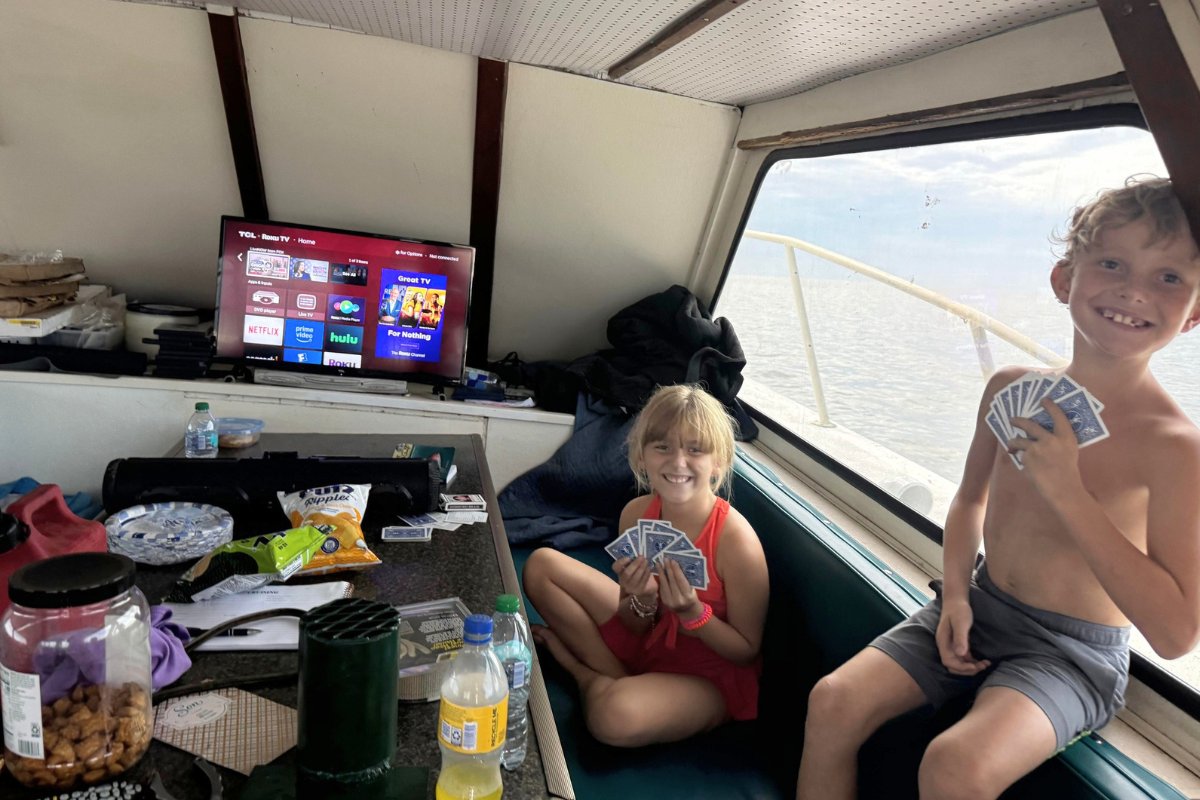 kids playing in air-conditioned cabin on offshore charter fishing trip out of fort morgan