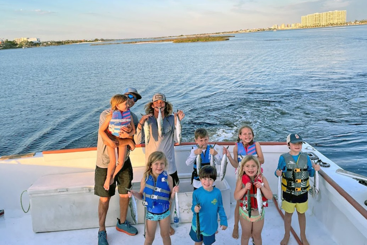 kids on a trolling trip showing of their spanish mackerel catch