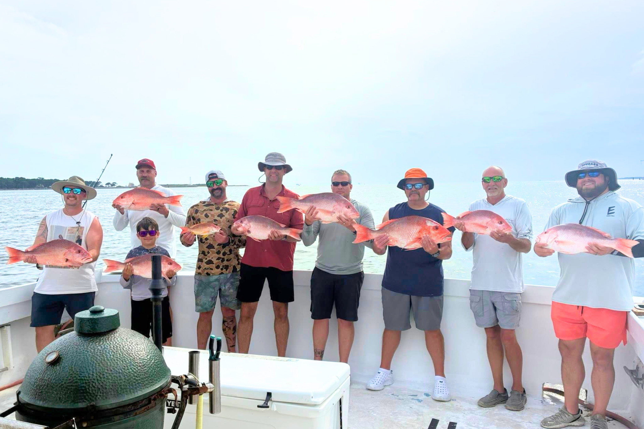 large group of fishermen holding red snapper aboard the no doubt caught off the shore of fort morgan