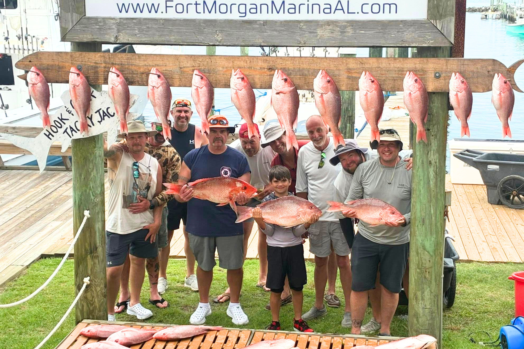 group of fishermen holding red snapper at fort morgan marina