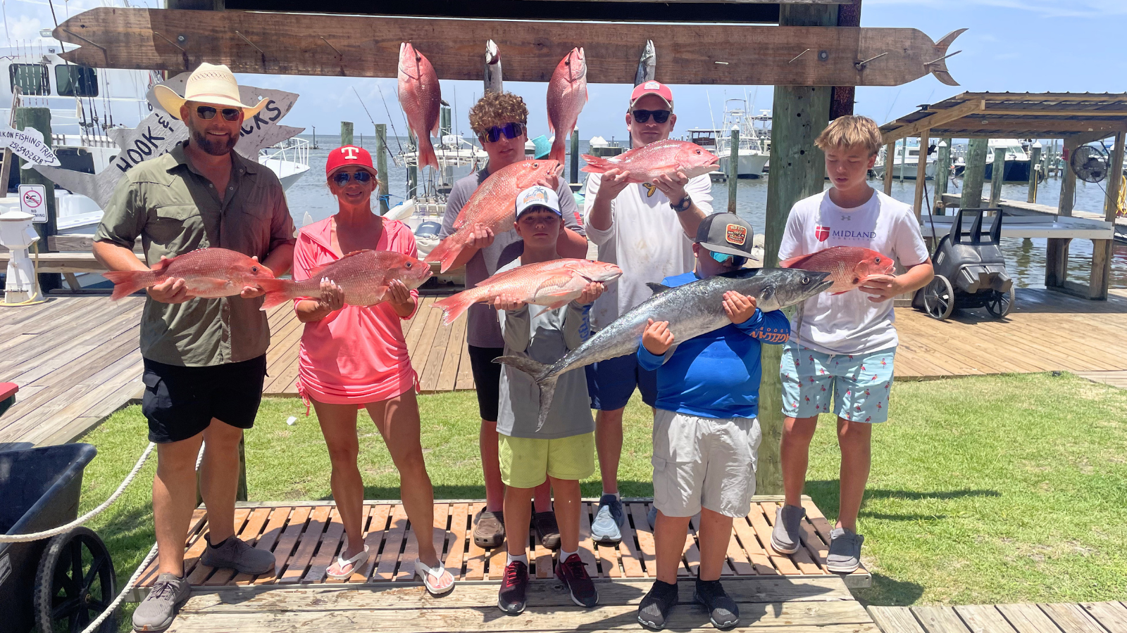 family group returning to Fort Morgan Marina with red snapper caught on charter boat in the Gulf of America