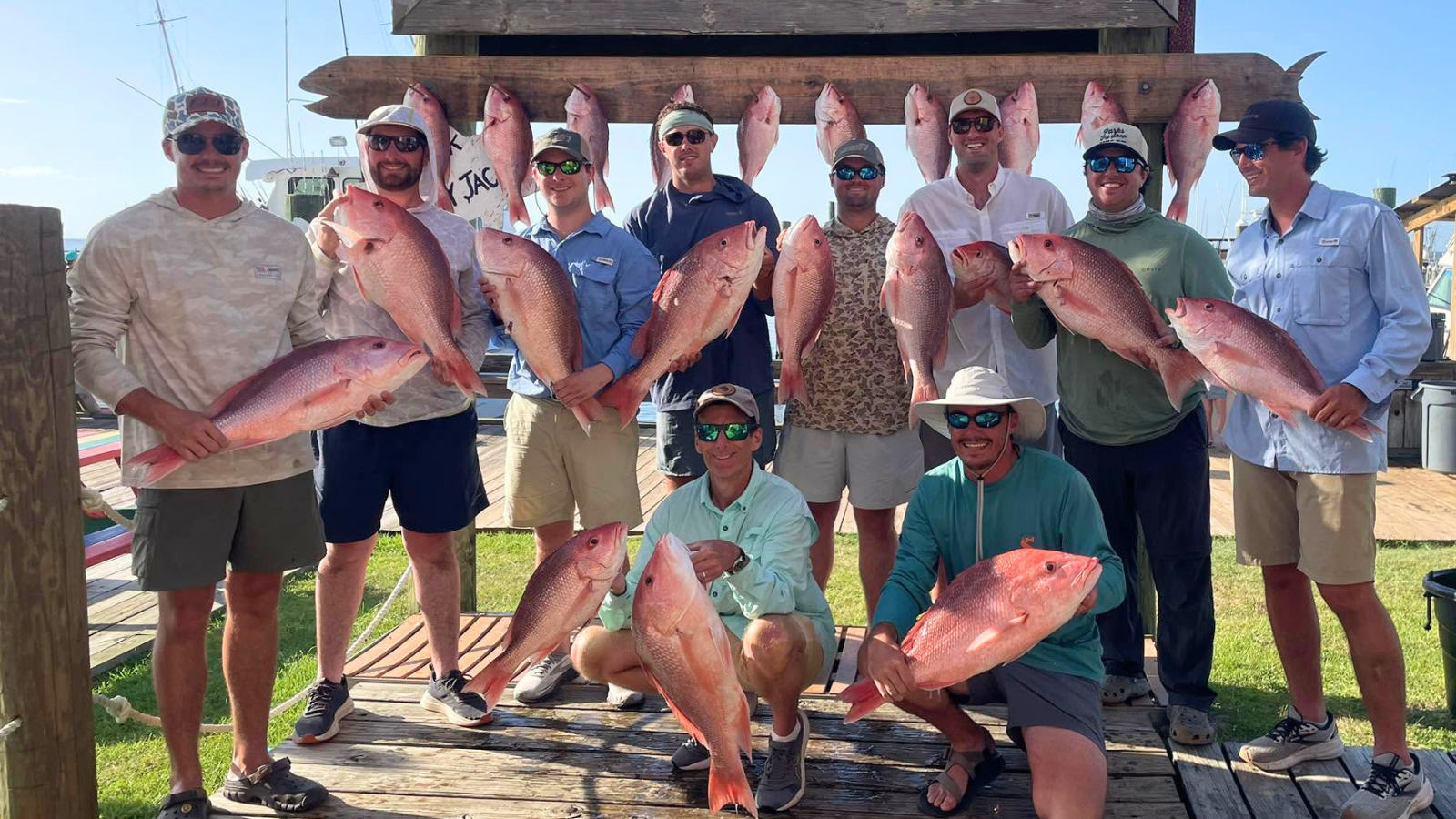 large group of guys back at fort morgan marina after a full day of offshore fishing on the alabama gulf coast