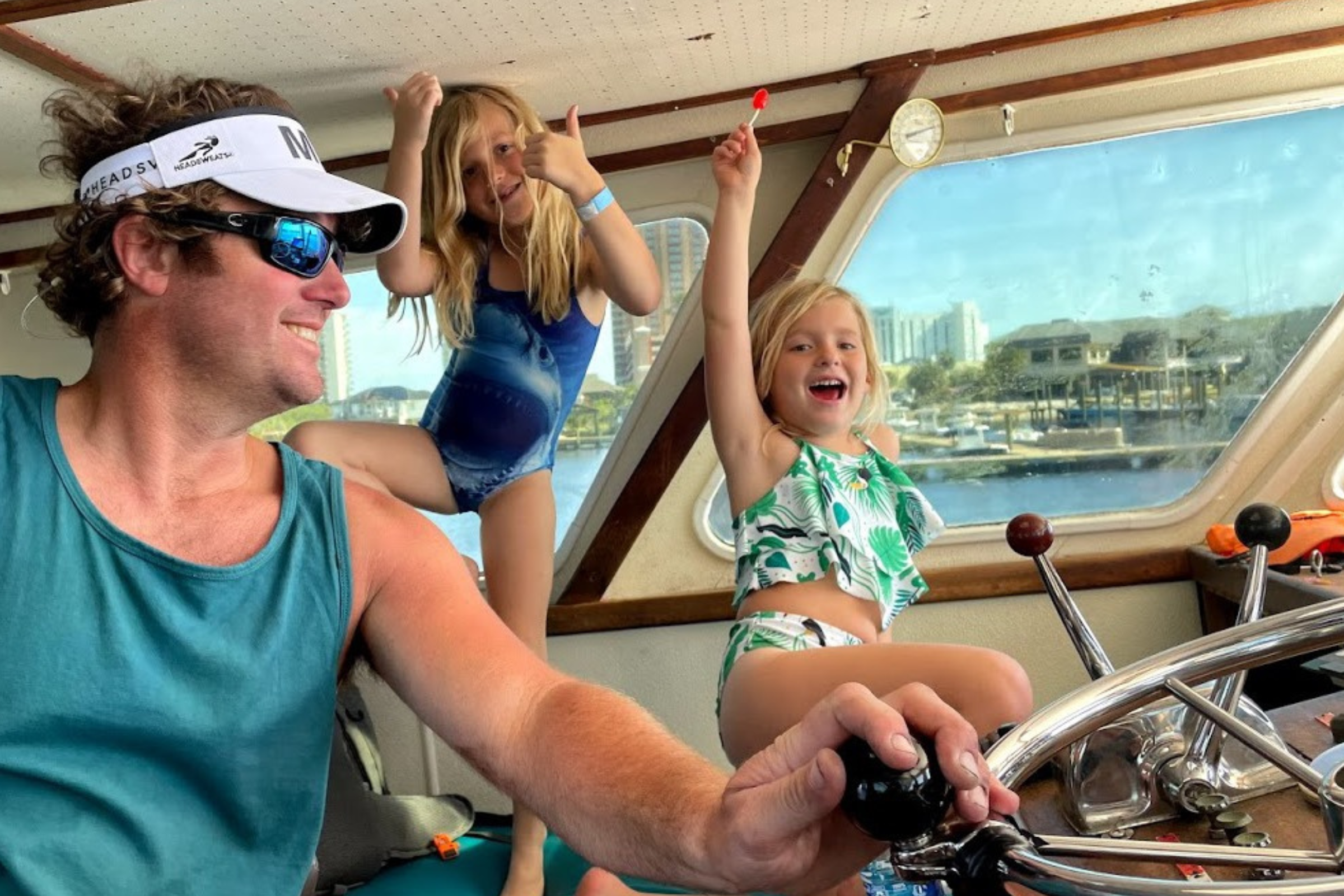 Captain Chase Newton in wheelhouse captaining his 60 foot offshore charter boat out of Fort Morgan marina
