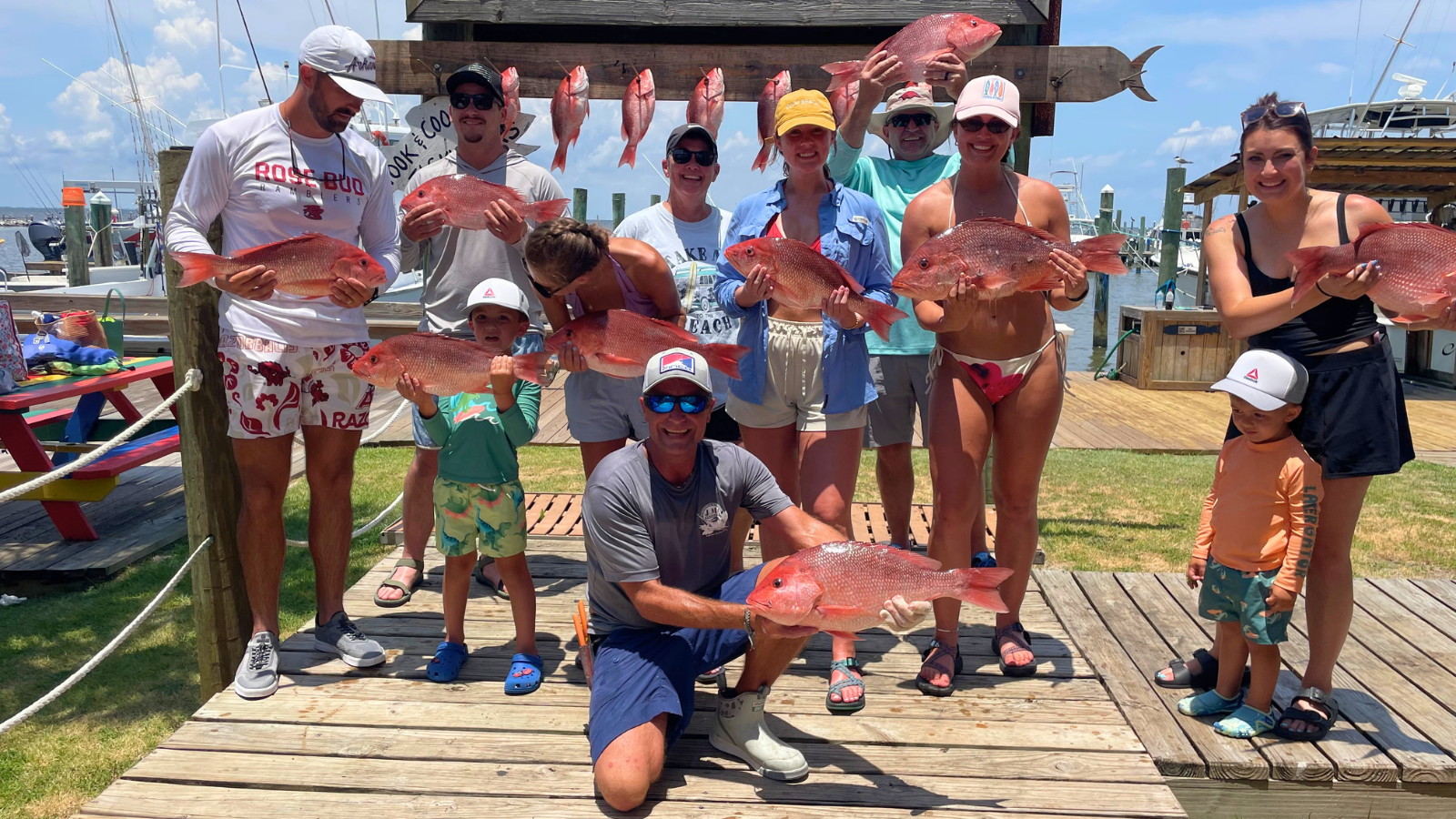 large group of guys holding red snapper caught off coast of Dauphin Island and Fort Morgan