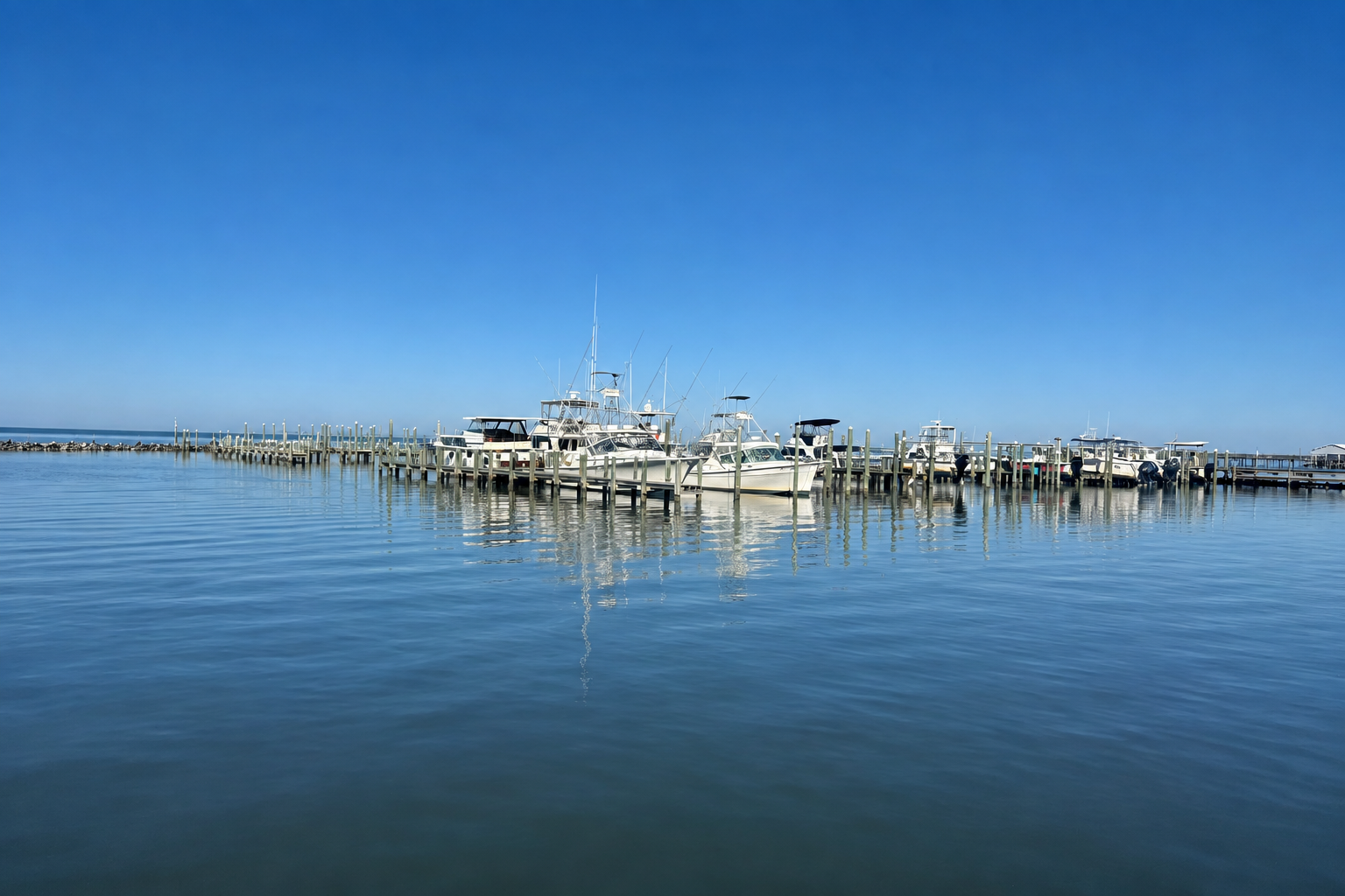 tranquil scene of boats and water look out onto Mobile Bay at Fort Morgan Marina