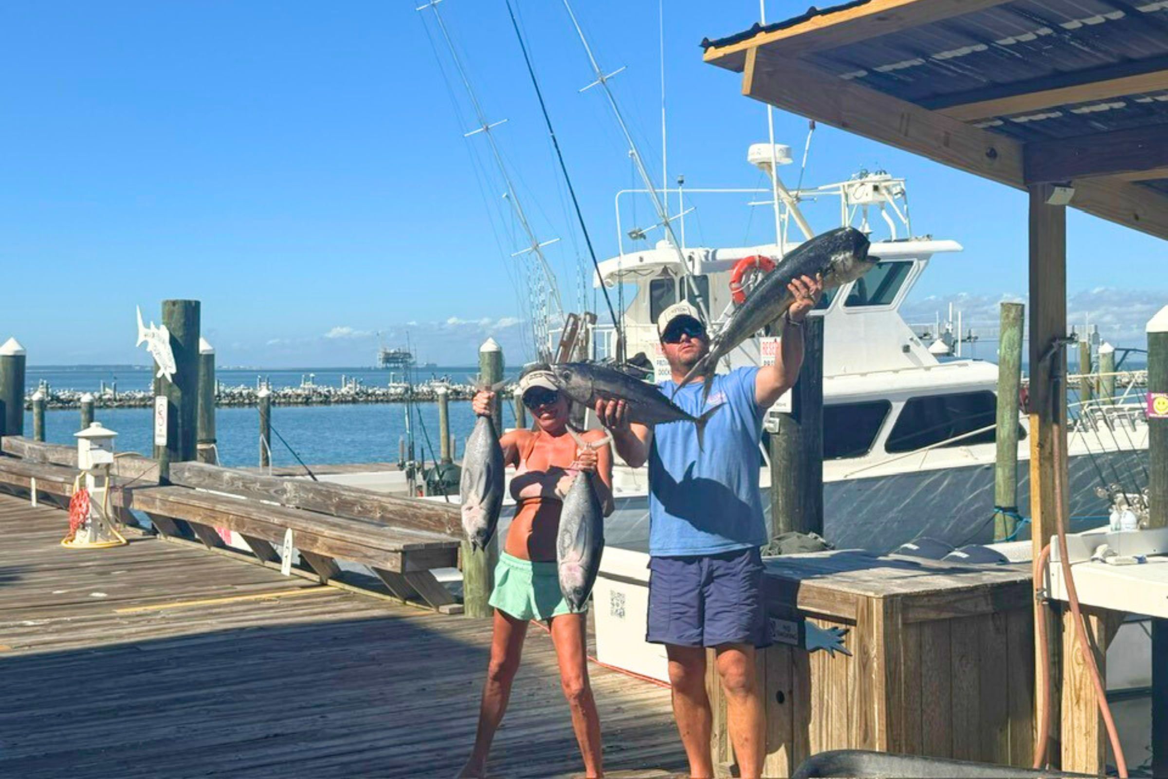a couple holding tuna caught onboard the no doubt after returning to fort morgan marina